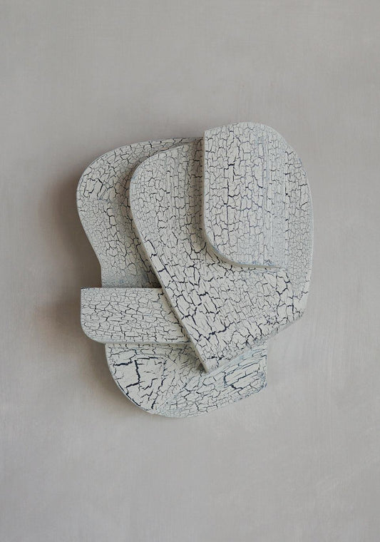 Crackle finish wall sculpture in organic form, 30 cm length, architectural design.