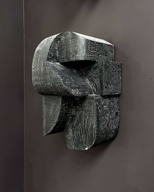 Ida Sculpture Large with hand-painted crackle finish on dark wall.