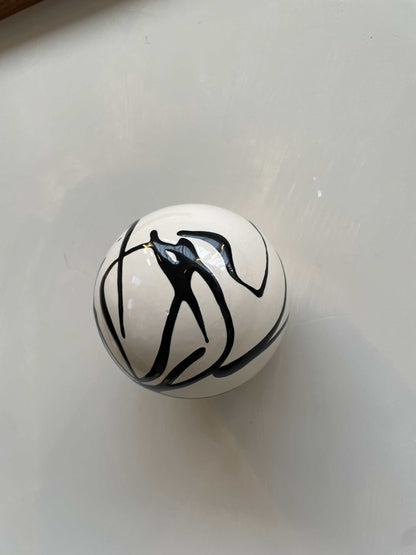 Handcrafted ceramic ball with artsy swirl design, wall sculpture.