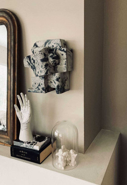 Mien Sculpture in marble effect with organic form, hand-painted, displayed on a wall.