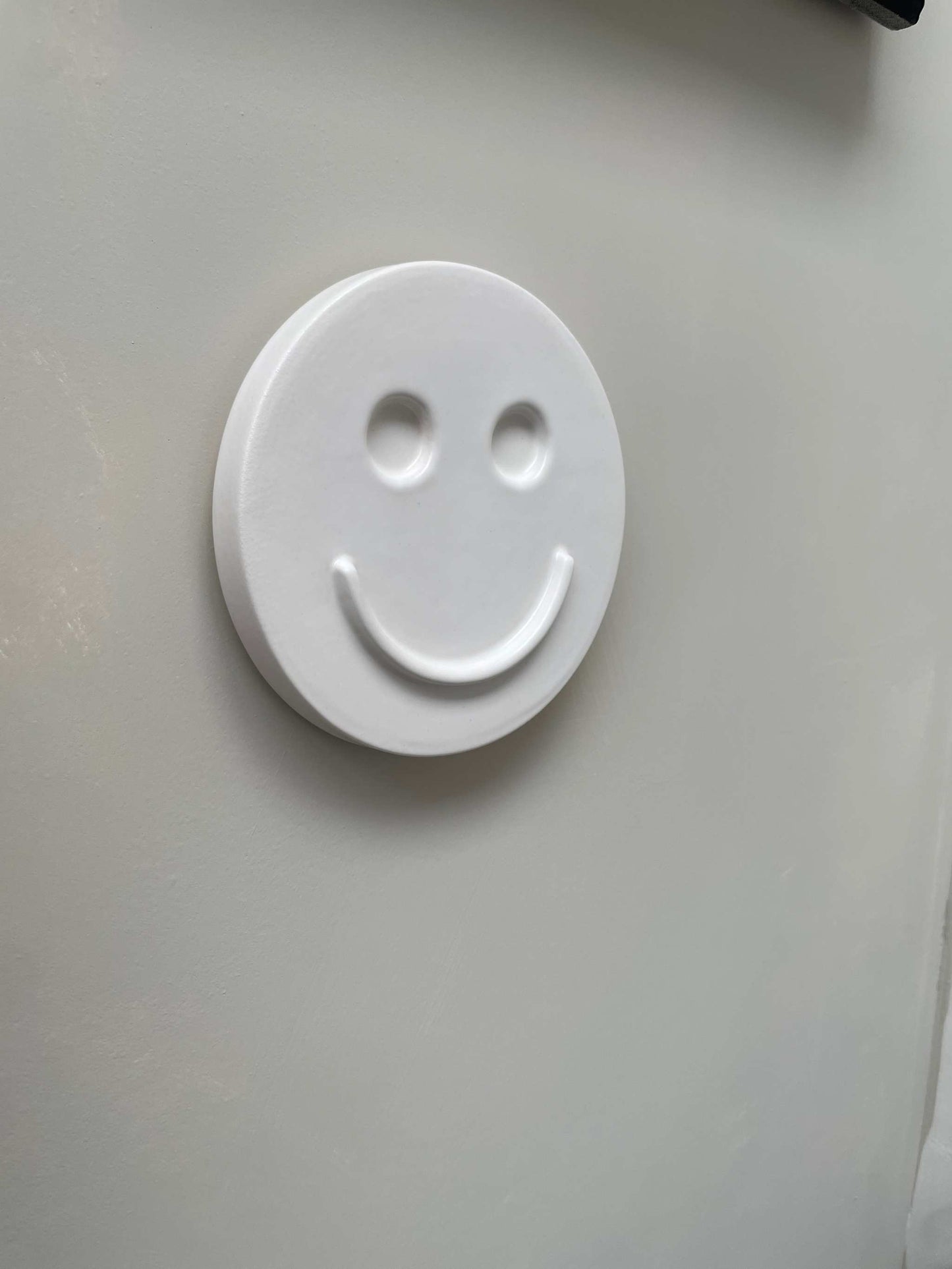 white ceramic wall art smiley face decoration handcrafted by Edith Beurskens