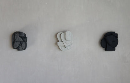Wall sculptures with organic forms and hand-painted finishes, featuring minimalist and unique designs, inspired by architectural elegance.