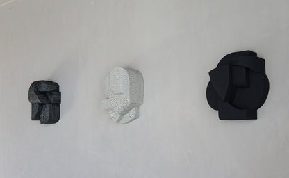 Wall sculptures with organic forms and hand-painted finishes in sand, featuring cubist and minimalist designs.