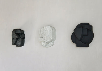 Organic wall sculptures with hand-painted crackle finish, inspired by architectural forms.