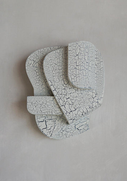Crackle finish wall sculpture in organic form, 30 cm length, architectural design.