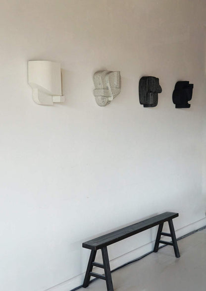 Hand-painted 'Helene' wall sculpture in sand finish, inspired by architectural forms, showcasing organic design by Ilse van Stoltz and Edith Beurskens.