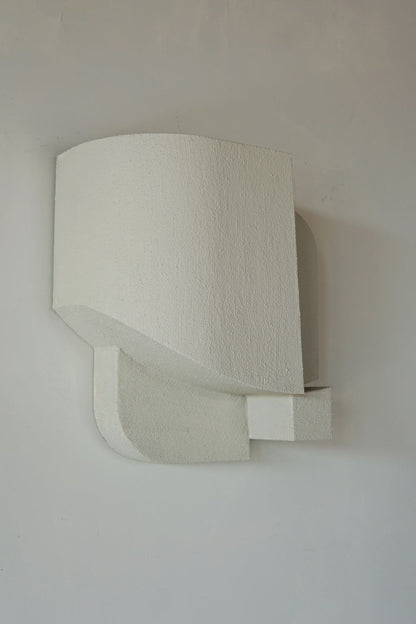 Organic wall sculpture with hand-painted sand finish.