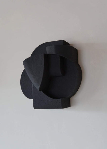 Organic wall sculpture with hand-painted finish and architectural design in sand color.