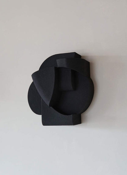 Organic wall sculpture with black hand-painted finish, inspired by architectural forms, size 30 cm x 27.4 cm x 16.7 cm.