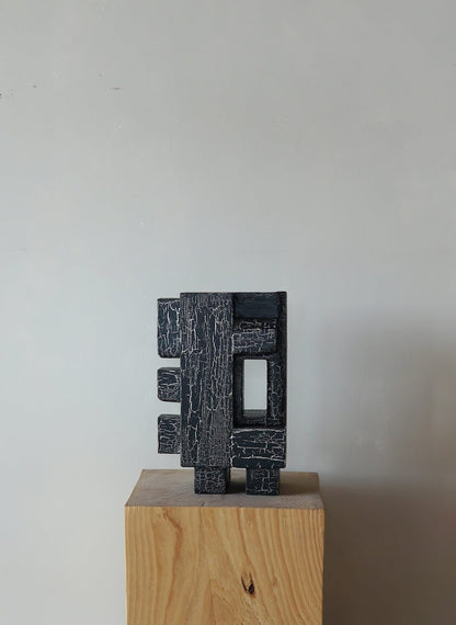 Odile Sculpture with crackle finish on wooden pedestal, organic architectural design.