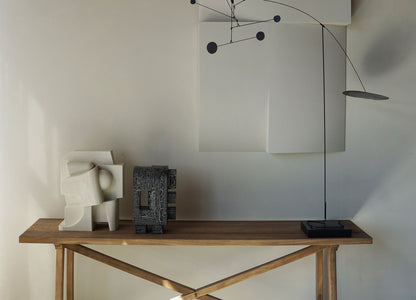 Odile Sculpture with crackle finish on wooden table against neutral wall backdrop.