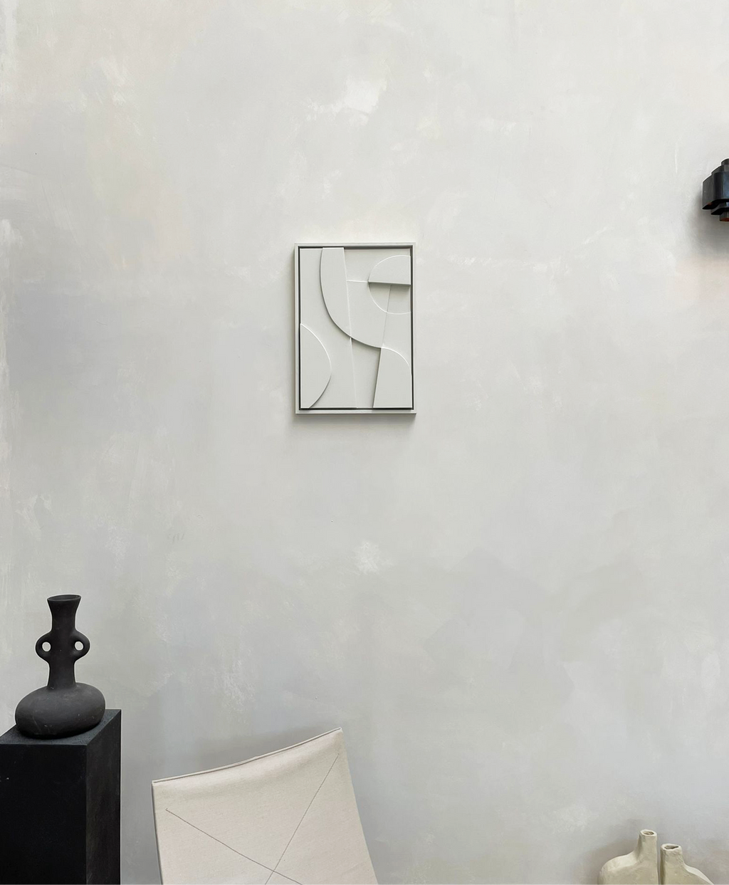 Modern abstract canvas print on wall in minimalist interior setting.