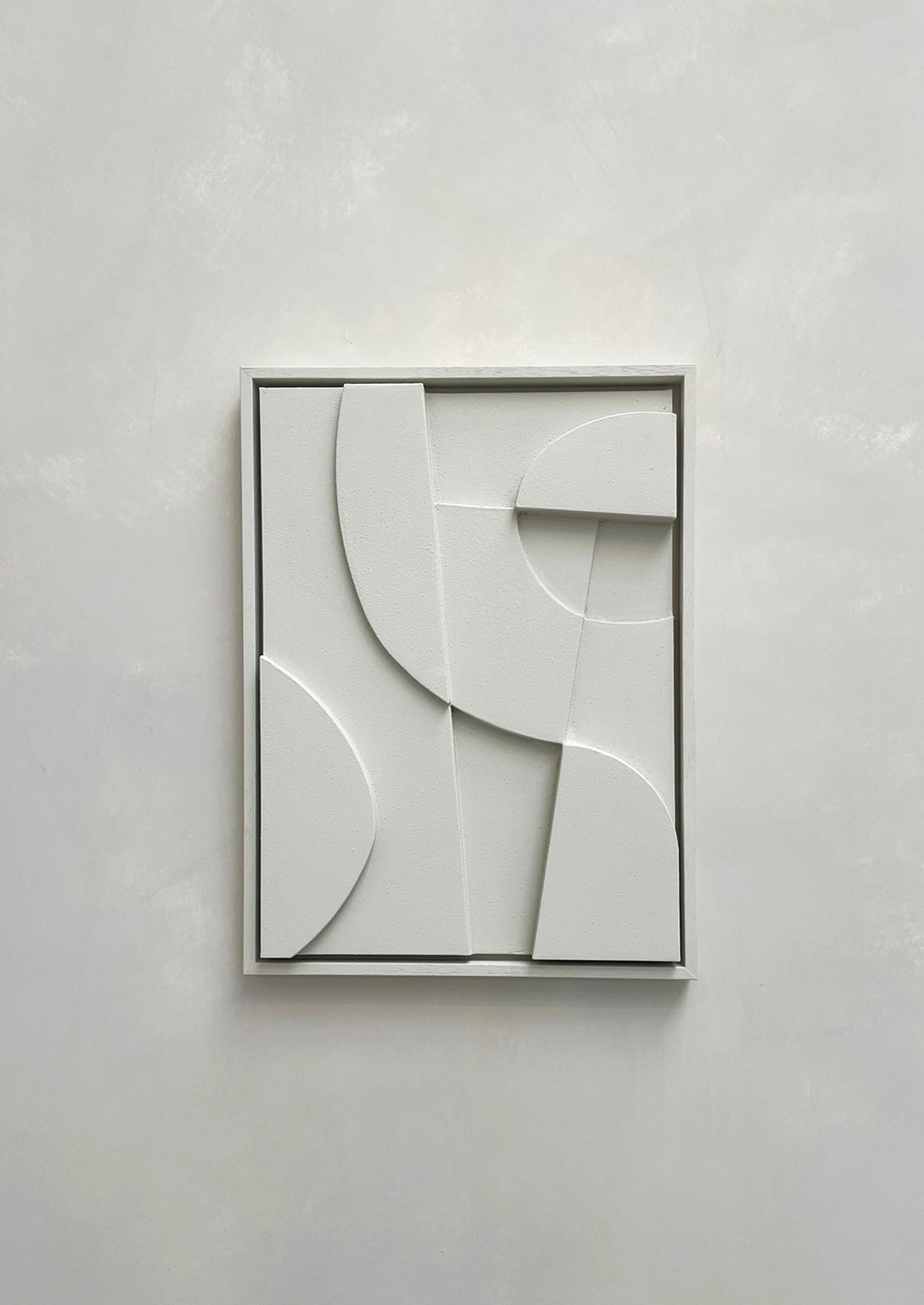 Minimalist abstract canvas print with geometric shapes in a white frame.