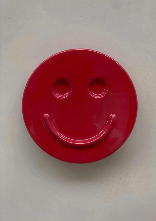 red ceramic HAPPY smiley face wall art by Edith Beurskens designed at Royal Goedewaagen
