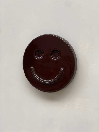 Eggplant SMILE ceramic artwork by Edith Beurskens, handcrafted and glazed.