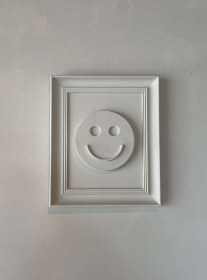Vintage Frame Happy artwork in shadow white, featuring a smiley face, crafted by Edith Beurskens.