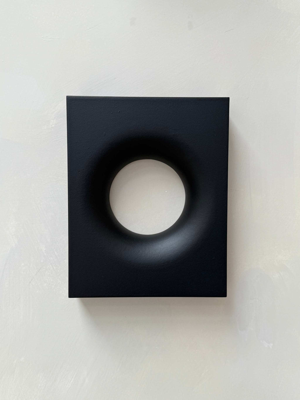 Black rectangular modern art piece with a smooth circular indentation, made from biodegradable PLA material with eco-friendly paint and resin finish, 30x24 cm.