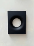 Black rectangular modern art piece with a smooth circular indentation, made from biodegradable PLA material with eco-friendly paint and resin finish, 30x24 cm.