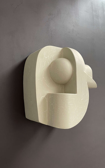 Large 'Ida BAL' sculpture with light crackle finish mounted on a wall.
