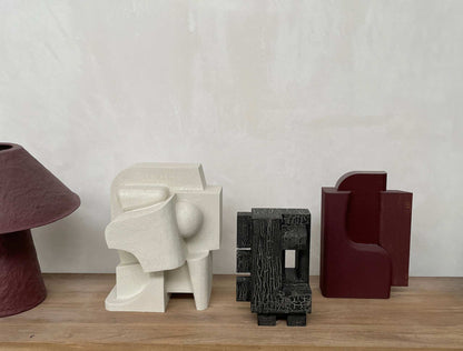 Odile Sculpture with crackle finish on wooden shelf, inspired by architectural forms.