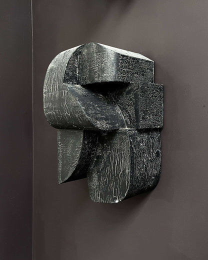 Ida Sculpture Large with hand-painted crackle finish on dark wall.