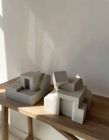 Erica sculpture in sand color with organic form and hand-painted finish on wooden table.