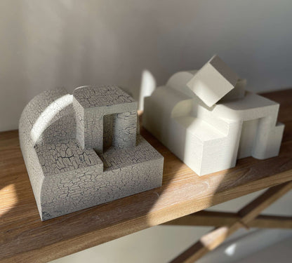 Bep Sculpture with crackle finish on a wooden shelf, showcasing organic architectural form.