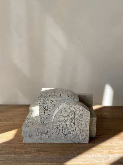 Bep Sculpture with crackle finish on wooden surface, organic architectural form.