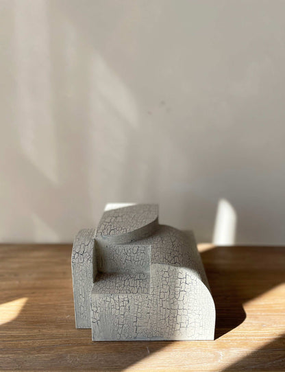 Organic 'Bep' sculpture with crackle finish displayed on a wooden surface.