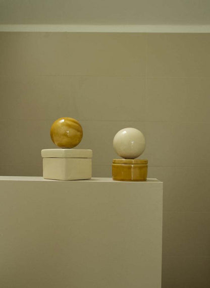 Ceramic box 'BOULE' in square shape, cognac and vanilla colors by Æ ART, displayed on a shelf.