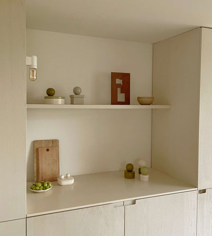 Ceramic 'BOULE' box displayed on a minimalist shelf, perfect for storing keepsakes.