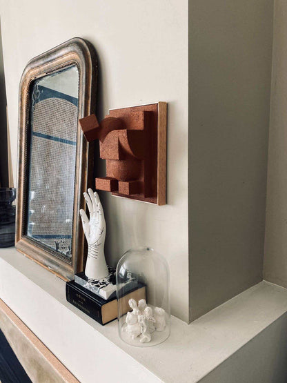 Charlotte sculpture in sand tone on wall, hand-painted organic form.