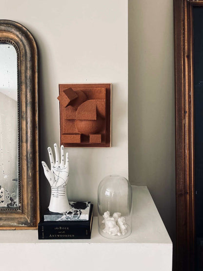 Charlotte Sculpture in sand color, organic form with a unique hand-painted finish, displayed on a wall.