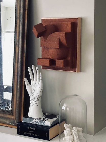 Charlotte Sculpture in sand color on wall with hand-painted finish, inspired by architectural forms.