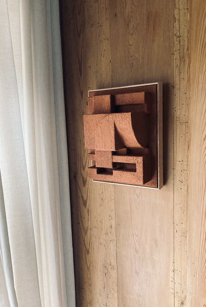 Bepy sculpture in sand finish on wooden wall, showcasing architectural elegance and organic form.