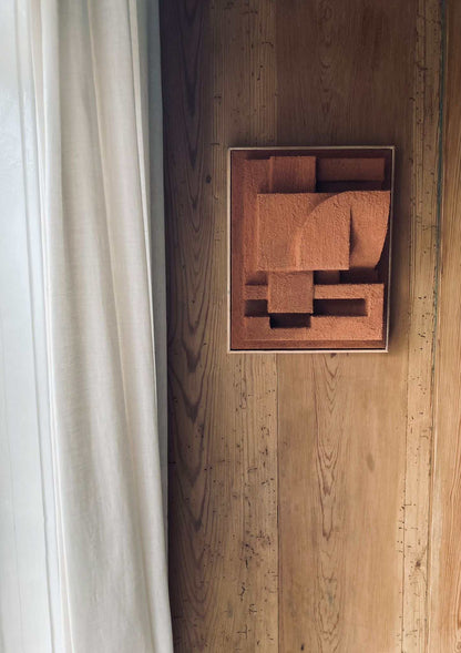 Bepy sculpture with hand-painted finish, organic form on wooden wall.