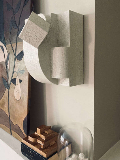 Erica wall sculpture with crackle finish in organic form, hand-painted, inspired by architectural pioneers.