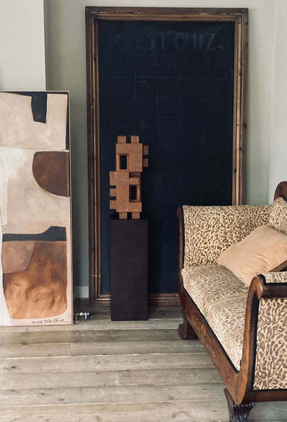 Odile sculpture with crackle finish, showcasing organic, architectural design in a room setting.