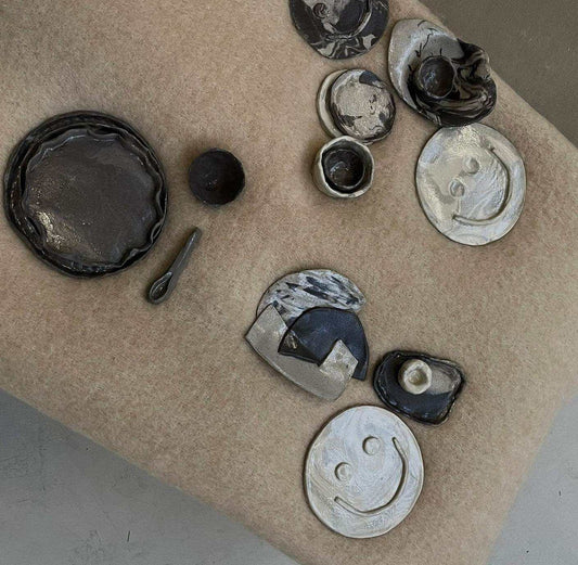 Ceramic workshop creations with swirl plates and charming cups.