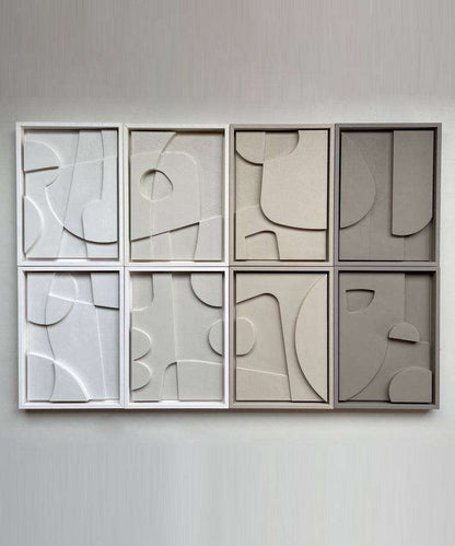 Handmade abstract art pieces with sand texture and eco-paint in white and gray frames.