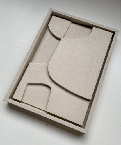 Handmade biodegradable art piece in a sand-finished frame.