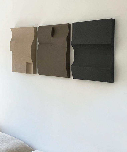 Modern art shapes in dark fog, attic, and anthracite on a wall.
