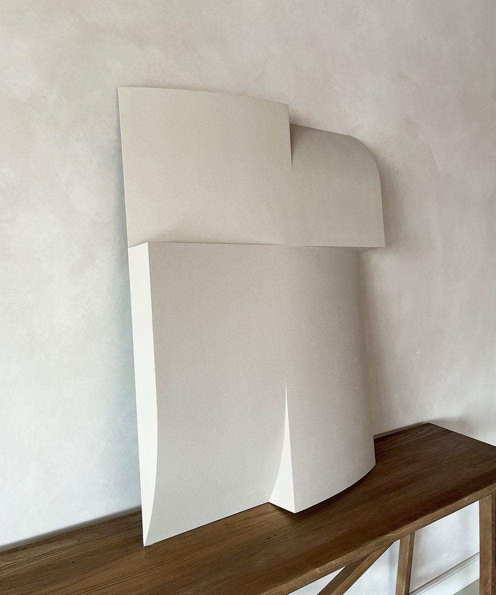 Modern art piece made of biodegradable PLA with sand texture and eco-paint on a wooden surface.