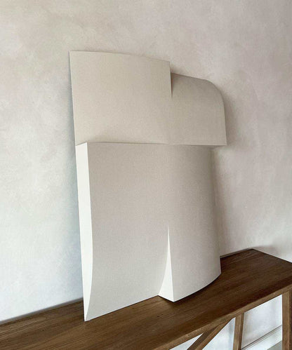 Modern art piece made of biodegradable PLA with sand texture and eco-paint on a wooden surface.