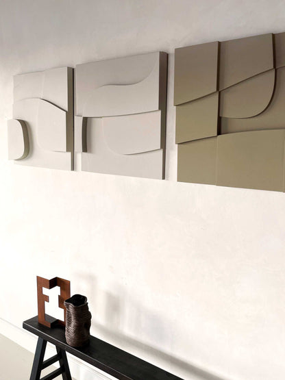 Handmade 3D art pieces on wall with eco-paint finish and textured surface.