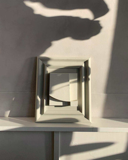 Vintage frame level artwork by Edith Beurskens with unique sand texture finish and eco-paint, featuring Hardwick and Shadow White colors, displayed against a softly lit wall.