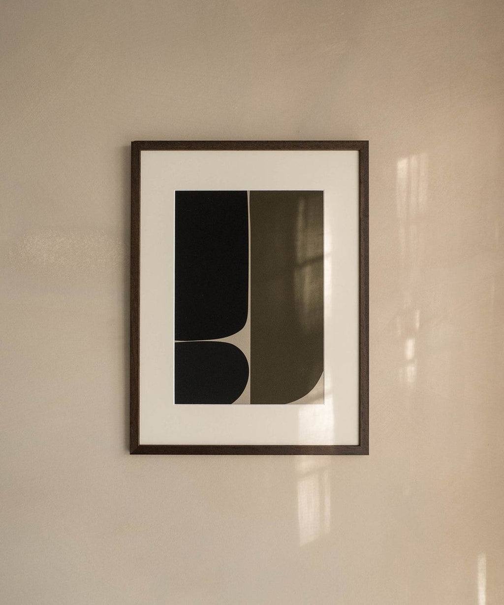 Artwork print "James" with black abstract design, printed on premium Hahnemühle paper, displayed in a frame on a beige wall.
