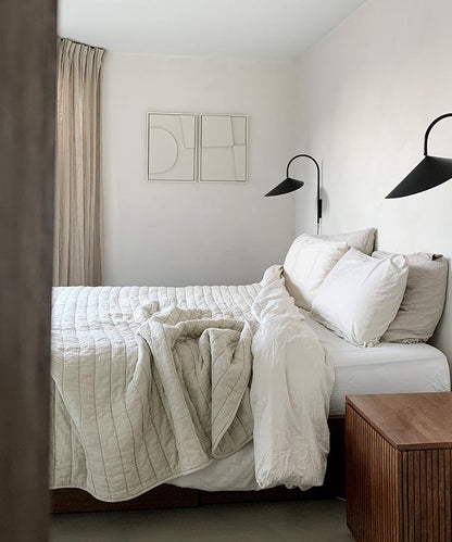 Minimalist bedroom featuring hand-made art pieces "Shape #6.1 + #6.2" on wall.