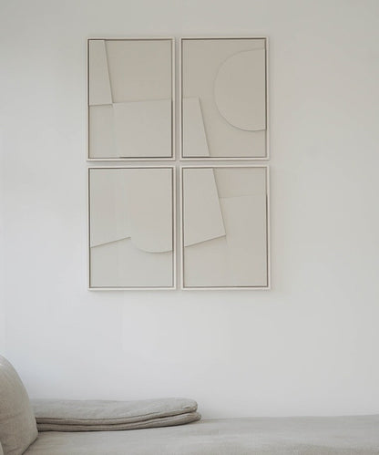 Handmade abstract art set of four panels with sand texture finish on a wall.