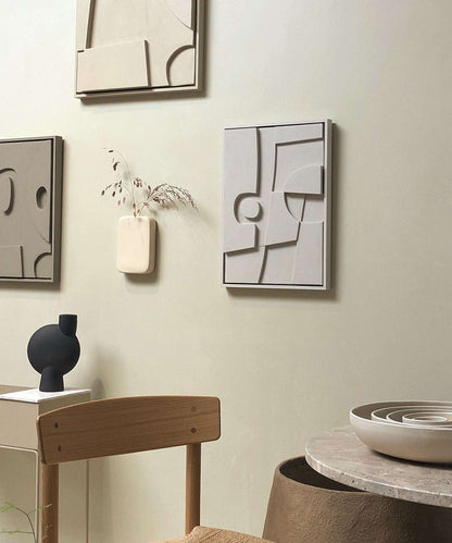 Handmade 20.8 Ebe art pieces on wall with minimalist decor.